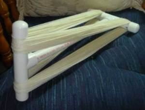 PVC Niddy Noddy with yarn wound on it.