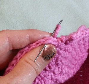 Pull the tail up thru the last st and use a needle to draw the end thru the top of the st joining to.