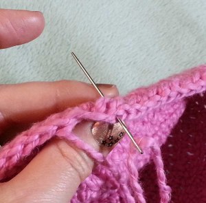 Use the needle to draw the tail back down thru the ending st and weave into the wrong side of the fabric.