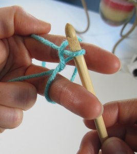 Pull up loop under wrkg yarn web