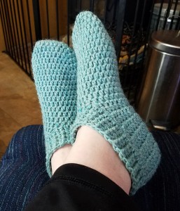 Green un-decorated slippers.