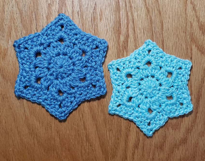 2 motifs side by side. Darker blue one on left larger than light blue one on right.